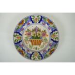 A polychrome Delft cabinet dish with floral decoration, mark to bae, AF, 25cm diameter