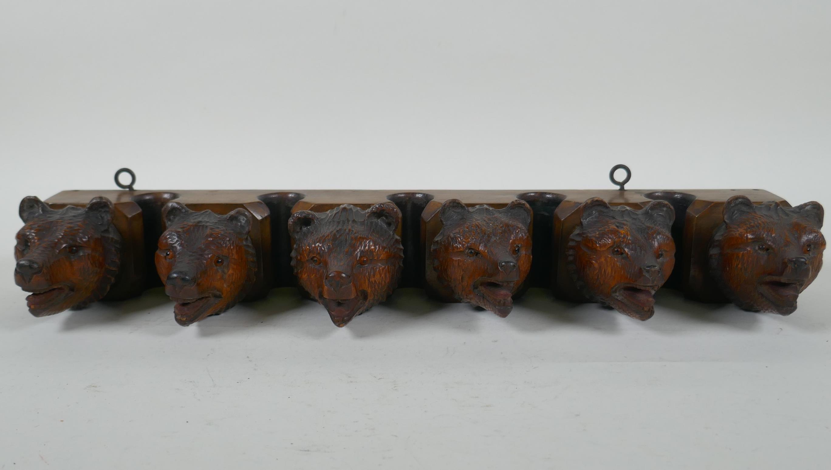 An antique Black Forest carved wood pipe rack with bear's head decoration, a pair of turned wood - Image 2 of 6