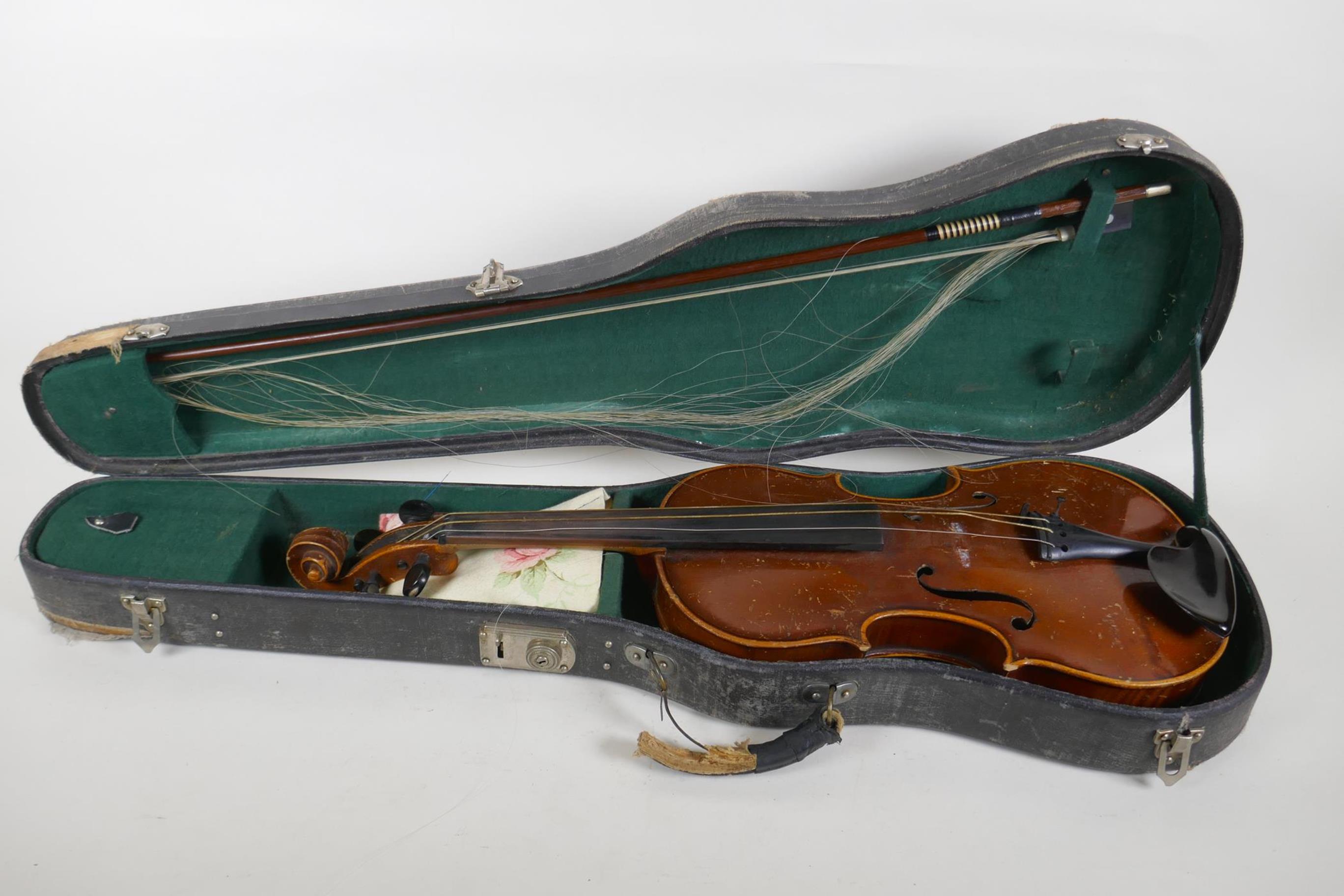 A violin and bow, the neck of the violin stamped RMB 1206, in a carry case, violin 59cm long