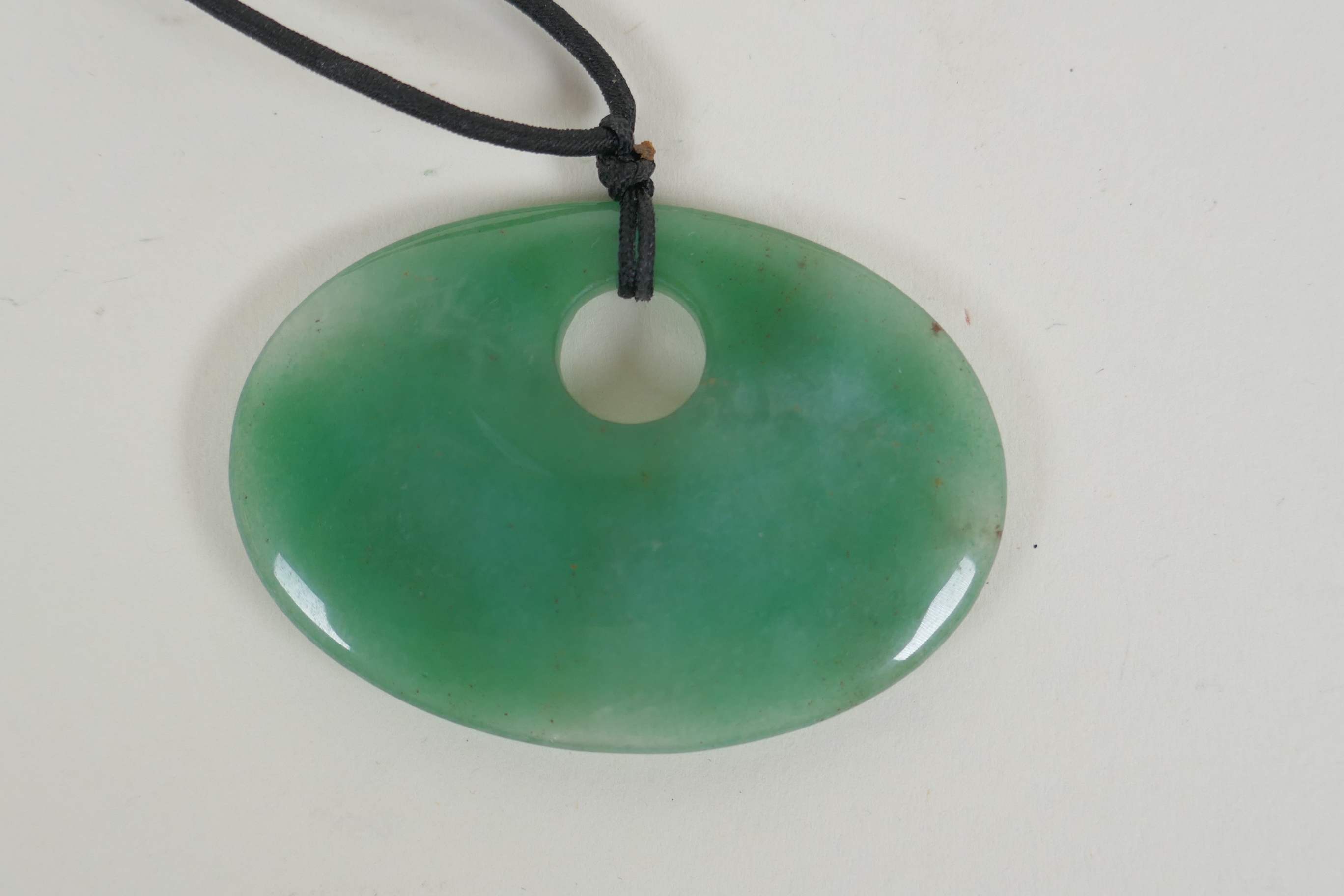 A Nephrite jade pendant necklace, 7 x 5cm - Image 2 of 2