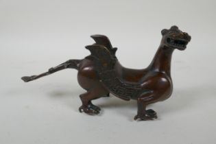 A Japanese filled bronze stylised dragon, 21cm long, indistinct 6 character mark to base