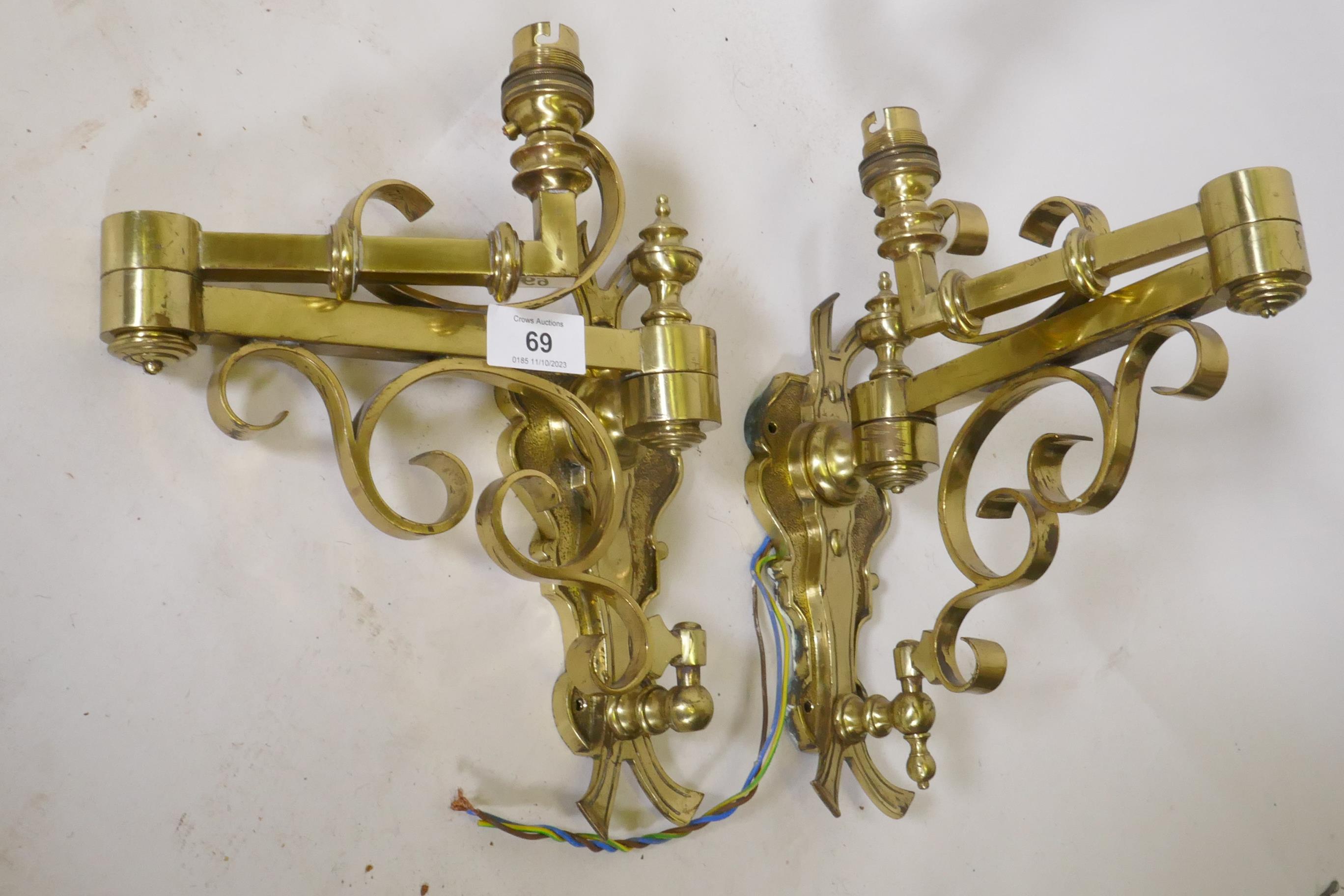 A pair of brass two fold wall sconces, 25cm high, 36cm extended