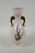 A Chinese blanc de chine porcelain two handled vase, with raised prunus blossom decoration picked