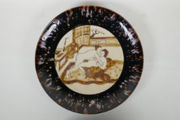 A Chinese Cizhou kiln charger with erotic decoration and a tortoise shell glaze rim, 34cm diameter