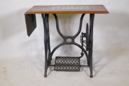 A Victorian cast iron sewing machine table, with later tiled top, 86 x 41 x 74cm