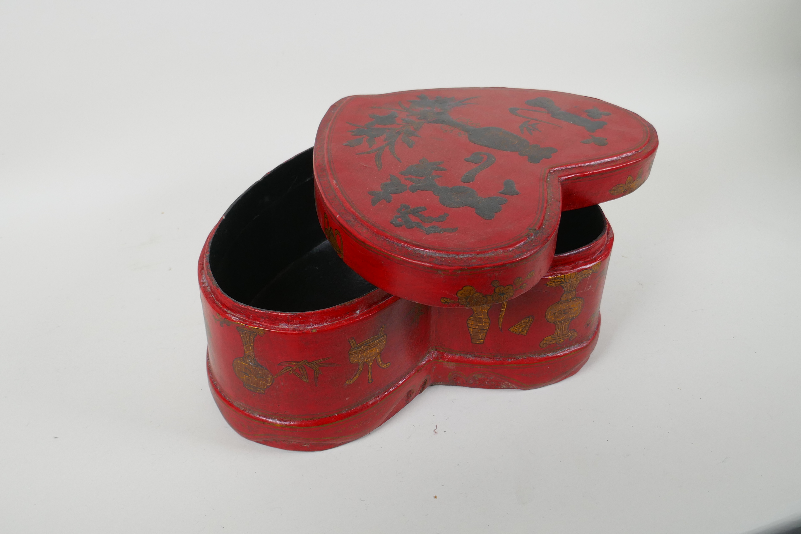 A Chinese red lacquered heart shaped box decorated with objects of virtue in gilt, 32 x 26cm - Image 4 of 6