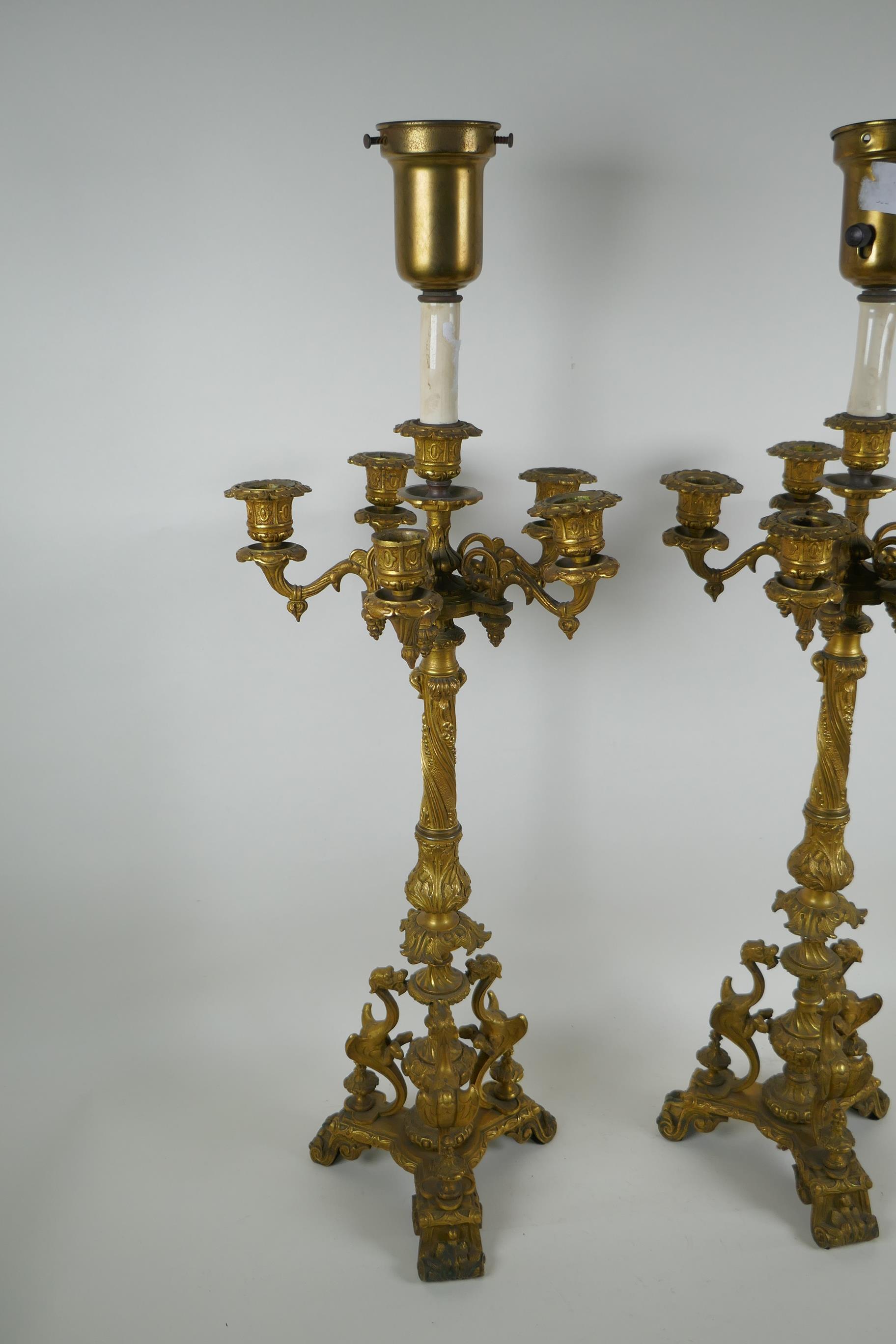 A pair of French ormolu five branch candlesticks on a tripod base with griffin decoration, the - Image 2 of 5