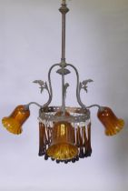 An early C19th continental pendant ceiling light with three branches and amber glass drops and