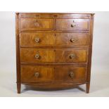 A Regency mahogany bowfront chest, with inlaid frieze and two over three drawers, flanked by