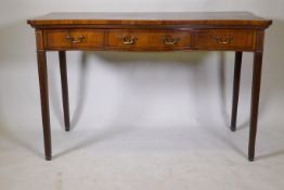 A Georgian inlaid mahogany serpentine front serving table, with single drawer and two fake, raised