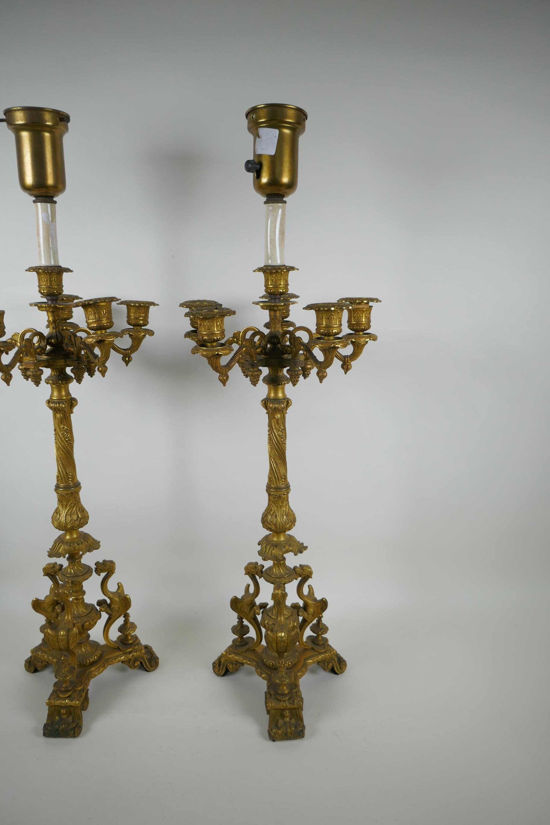 A pair of French ormolu five branch candlesticks on a tripod base with griffin decoration, the - Image 3 of 5