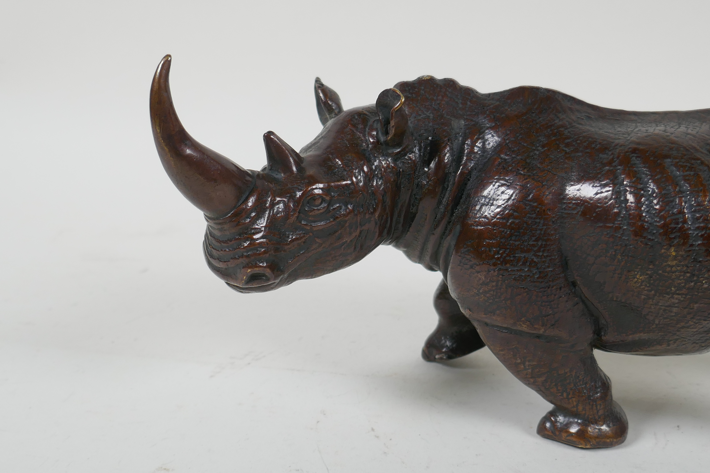 A filled bronze rhinoceros, 23cm long - Image 2 of 4