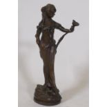 An Art Nouveau style bronze figure of a woman bearing a lily, inscribed Lola, 32cm high