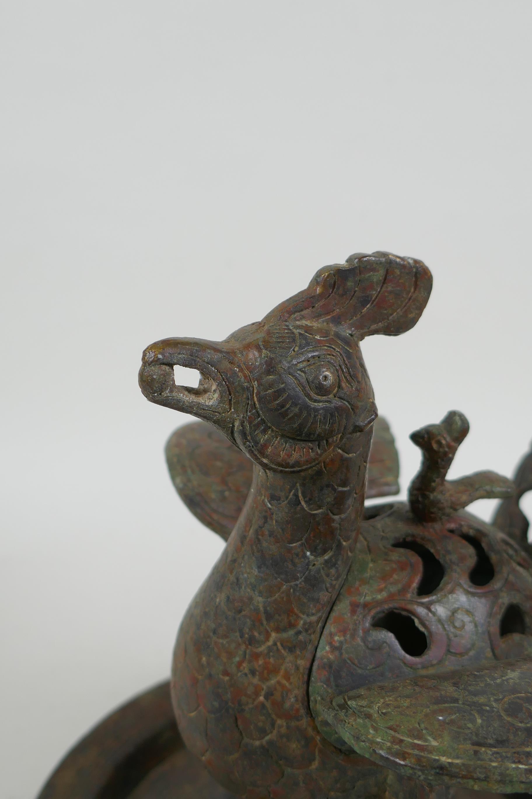 A Chinese archaic style bronzed metal censer in the form of a phoenix standing on a platter, 20cm - Image 2 of 5