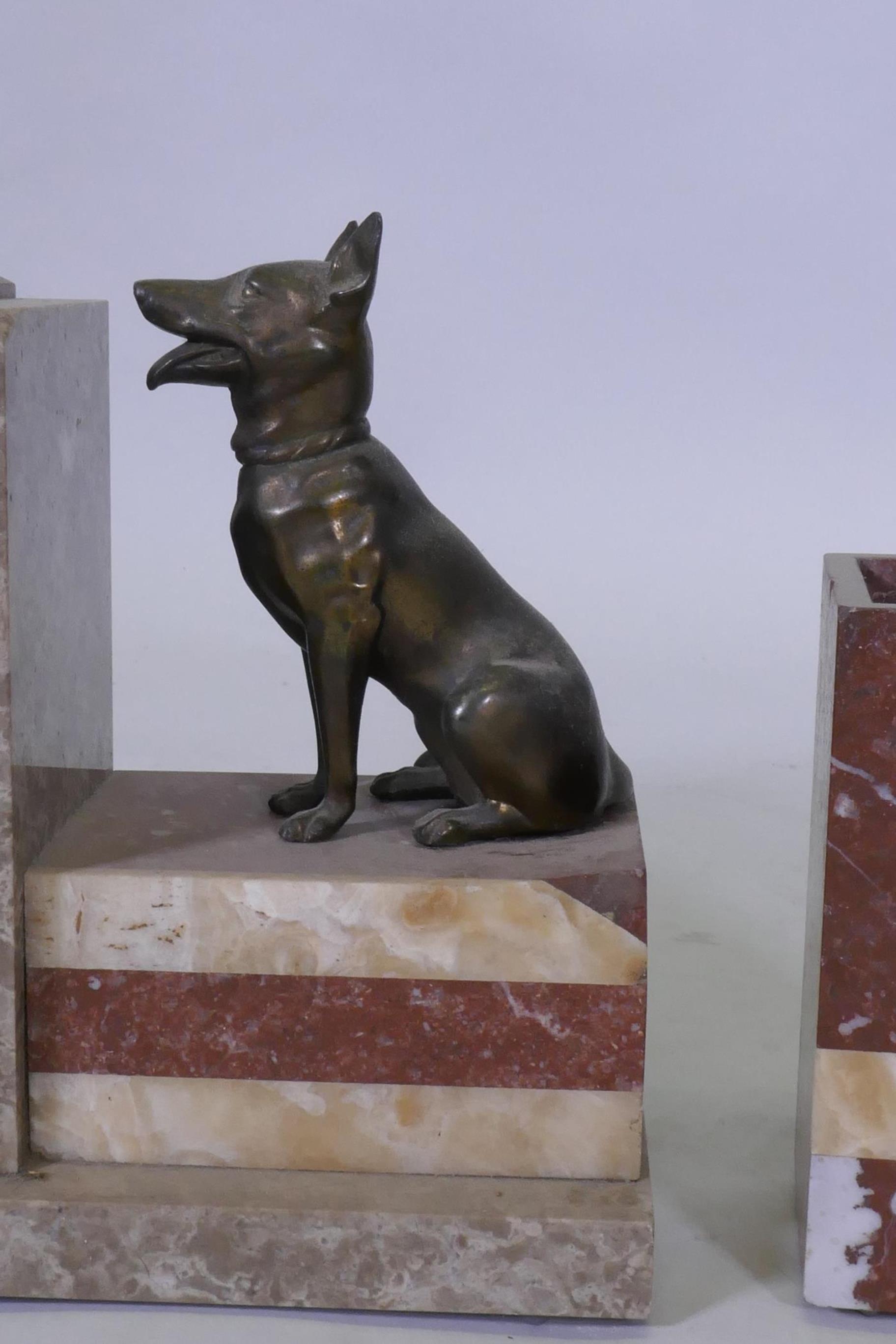 An Art Deco French rouge marble mantel clock garniture, with bronzed metal figures of Alsatian dogs, - Image 2 of 4