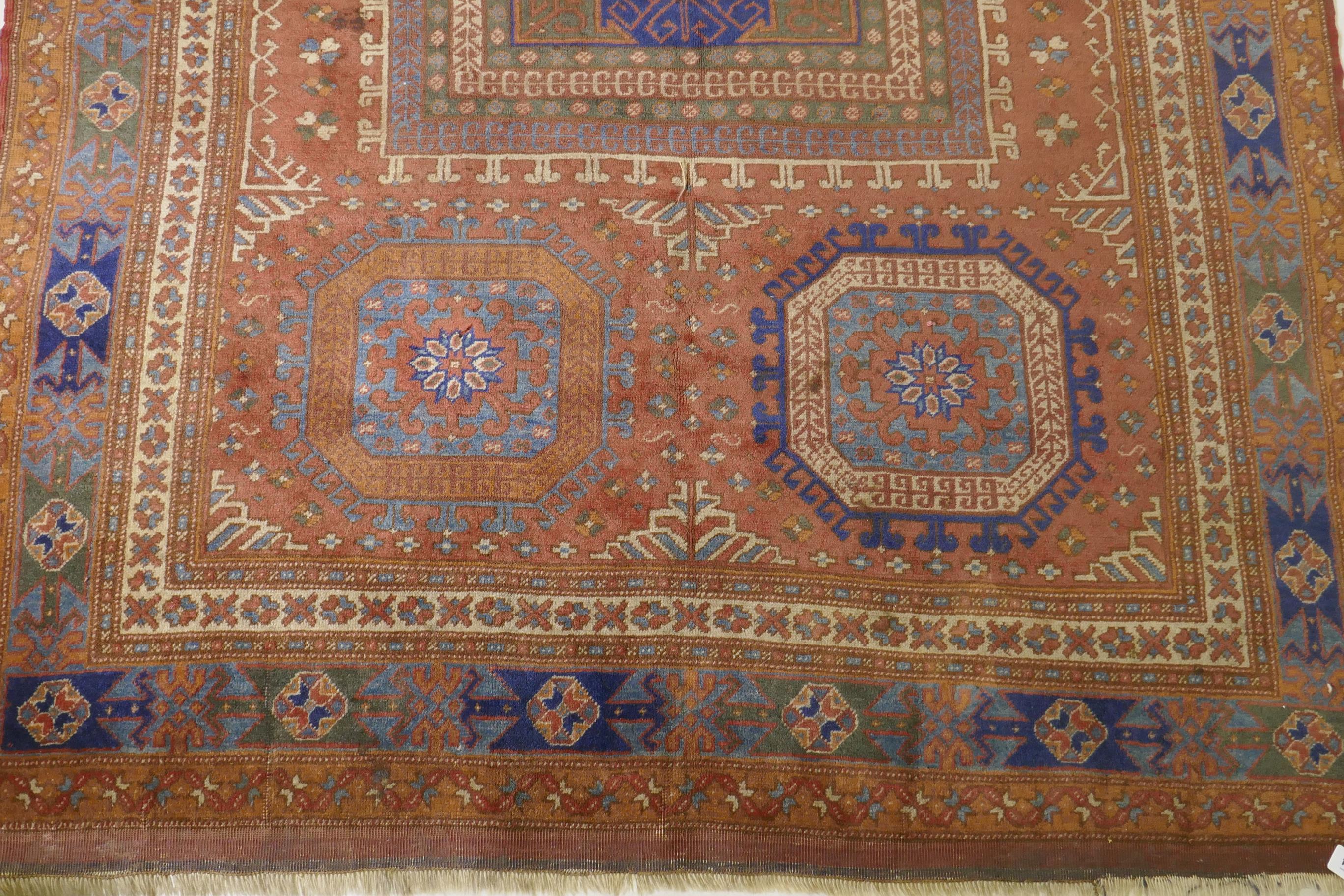 An antique Bergama carpet, with geometric designs on a terracotta coloured field and soft sheen to - Image 2 of 6