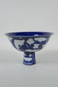 A Chinese sacrificial blue glazed porcelain stem bowl decorated with carp in a lotus pond, Xuande