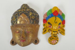 An Indian carved and painted wood Ganesh wall mask and another carved and gilt Buddha mask,