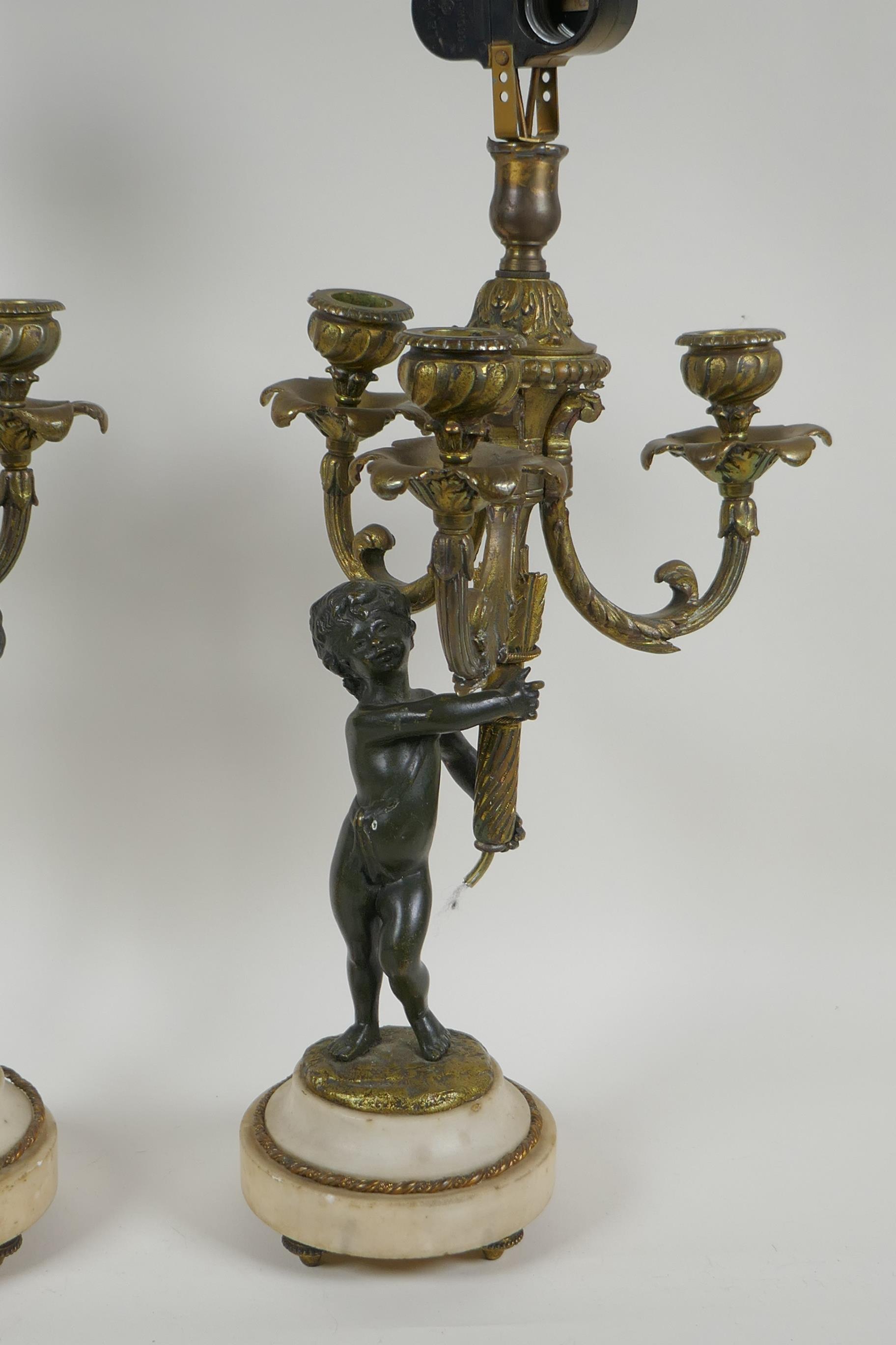 A pair of bronze and ormolu cherub three branch candlesticks converted to a lamp, 60cm high - Image 3 of 4