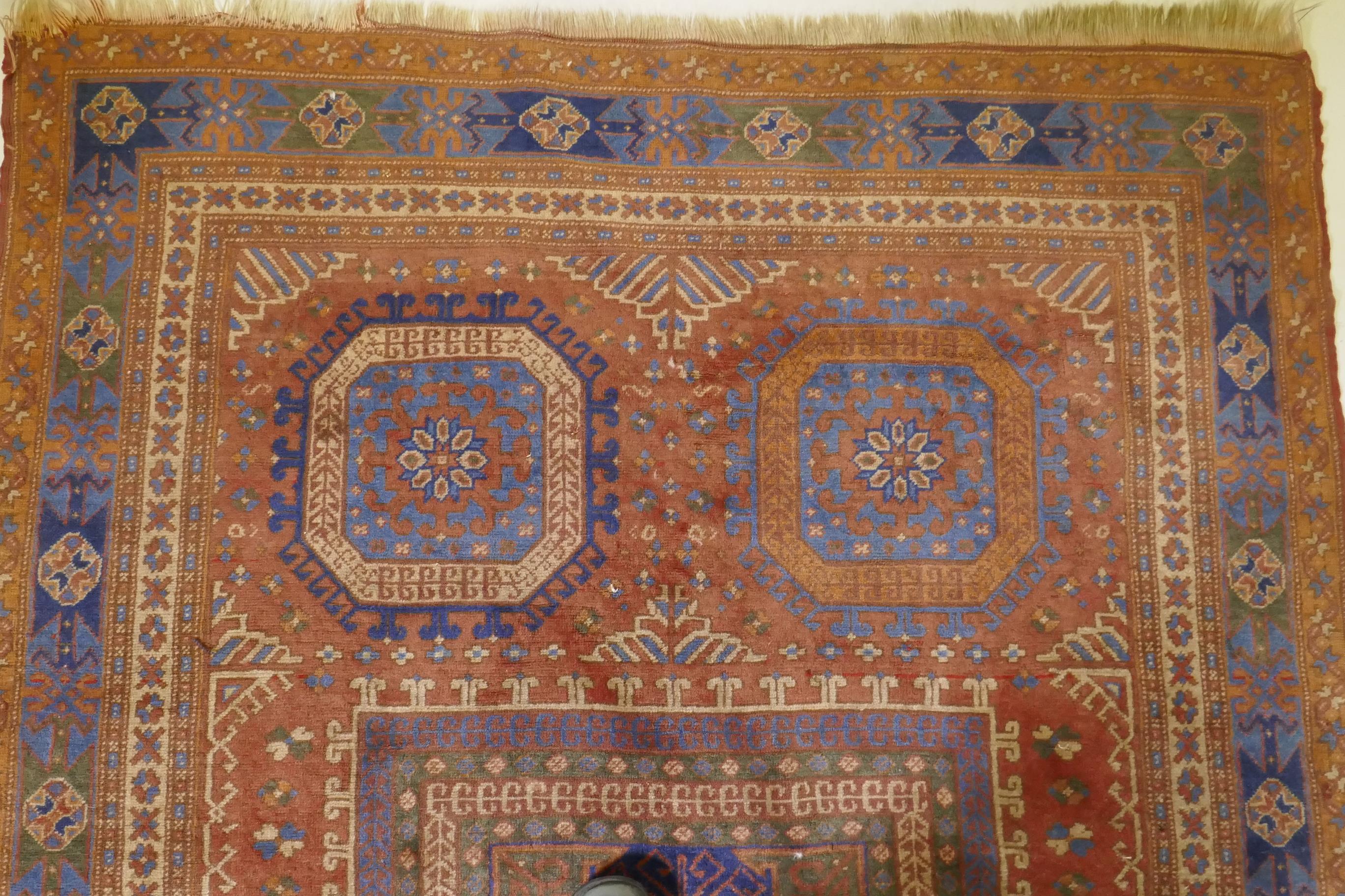 An antique Bergama carpet, with geometric designs on a terracotta coloured field and soft sheen to - Image 4 of 6