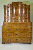 An C18th/C19th Continental walnut secretaire a trois corps, inlaid with burr walnut panels, the