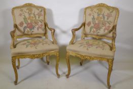 A pair of late C19th carved giltwood elbow chairs, labelled Bertram & Son, 100 and 101, Dean Street,