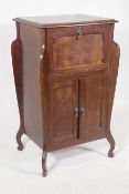 An early C20th Art Nouveau style mahogany music cabinet, with fall front and two cupboards, 55 x