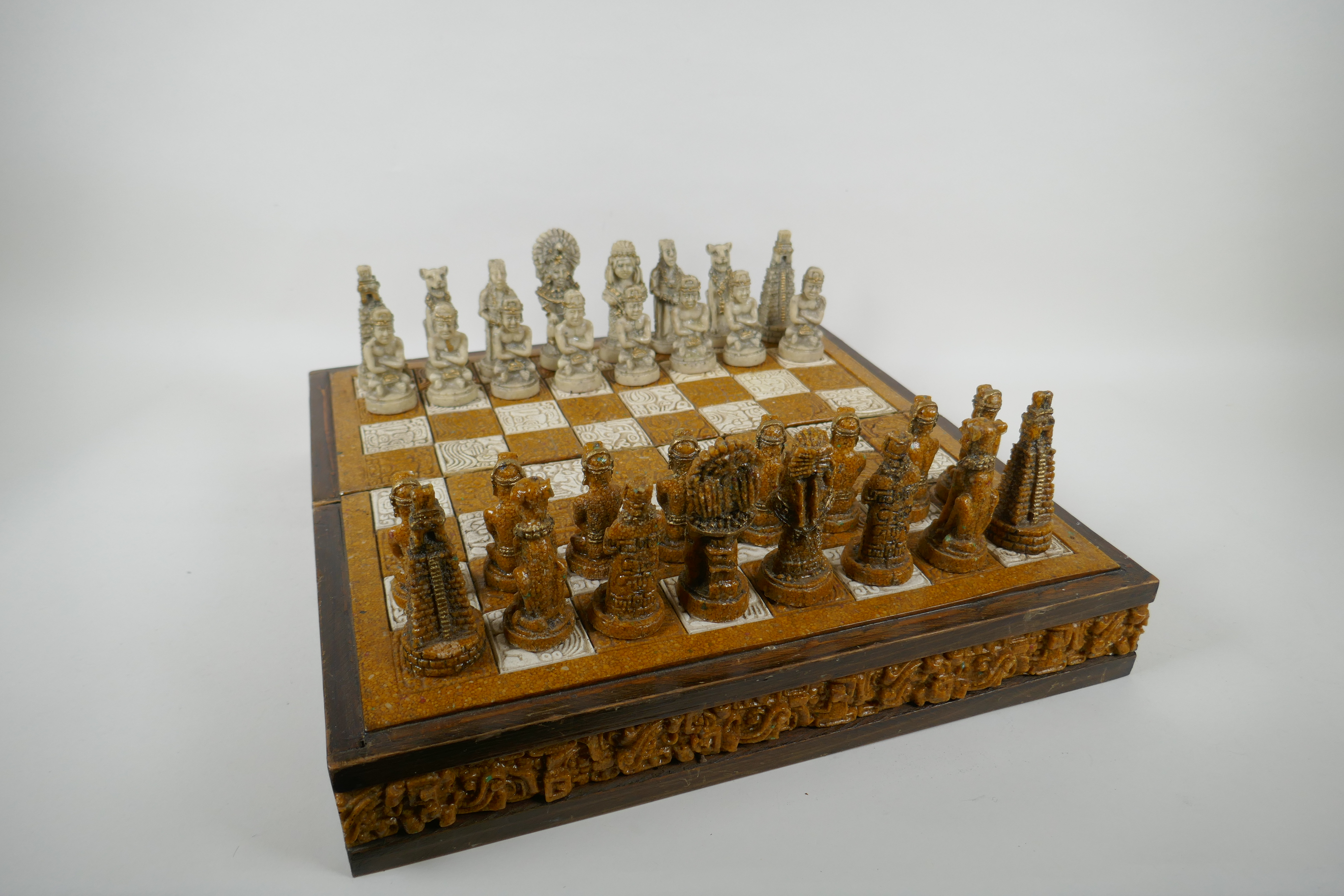A composition chess set in the form of Myan deities, complete, 40 x 40cm