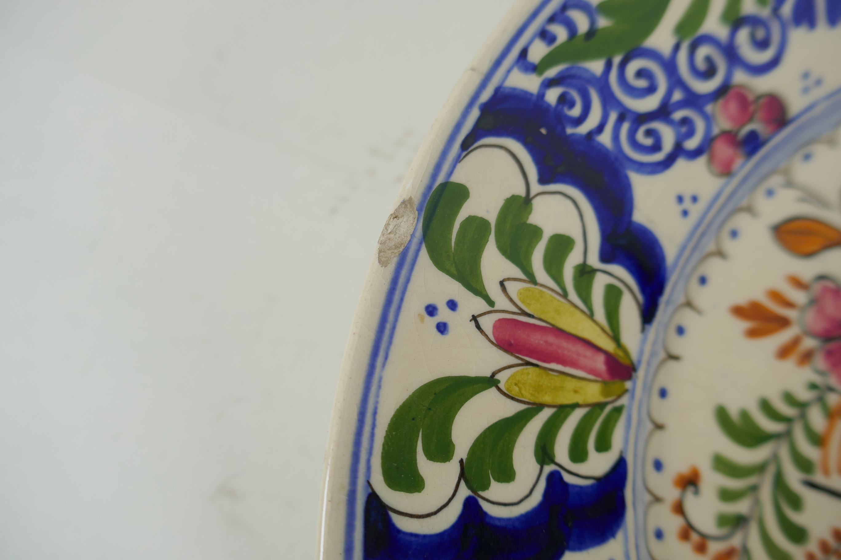 A polychrome Delft cabinet dish with floral decoration, mark to bae, AF, 25cm diameter - Image 2 of 6