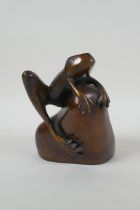 After Phil Vanderlei (American), a bronze figure of a frog on a rock, 15cm high