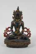 A Tibetan lacquered and gilt bronze Buddha holding a stupa, 22cm high