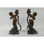 A pair of bronze cherub candlesticks/lamp bases, 30cm high