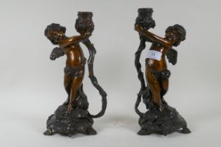 A pair of bronze cherub candlesticks/lamp bases, 30cm high