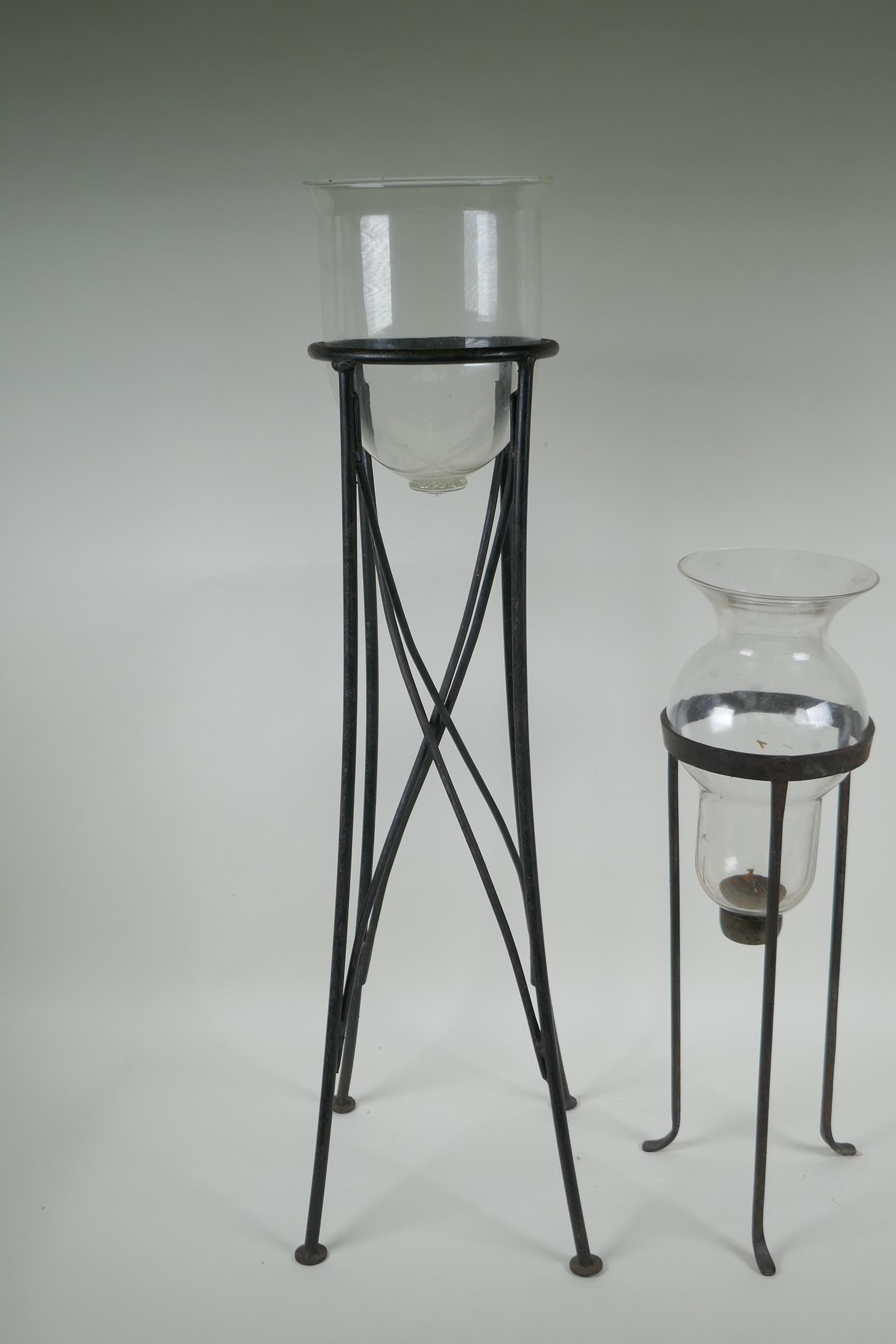 A glass hurricane vase on a wrought iron stand, and another, largest 76cm high - Image 2 of 3