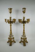 A pair of French ormolu five branch candlesticks on a tripod base with griffin decoration, the