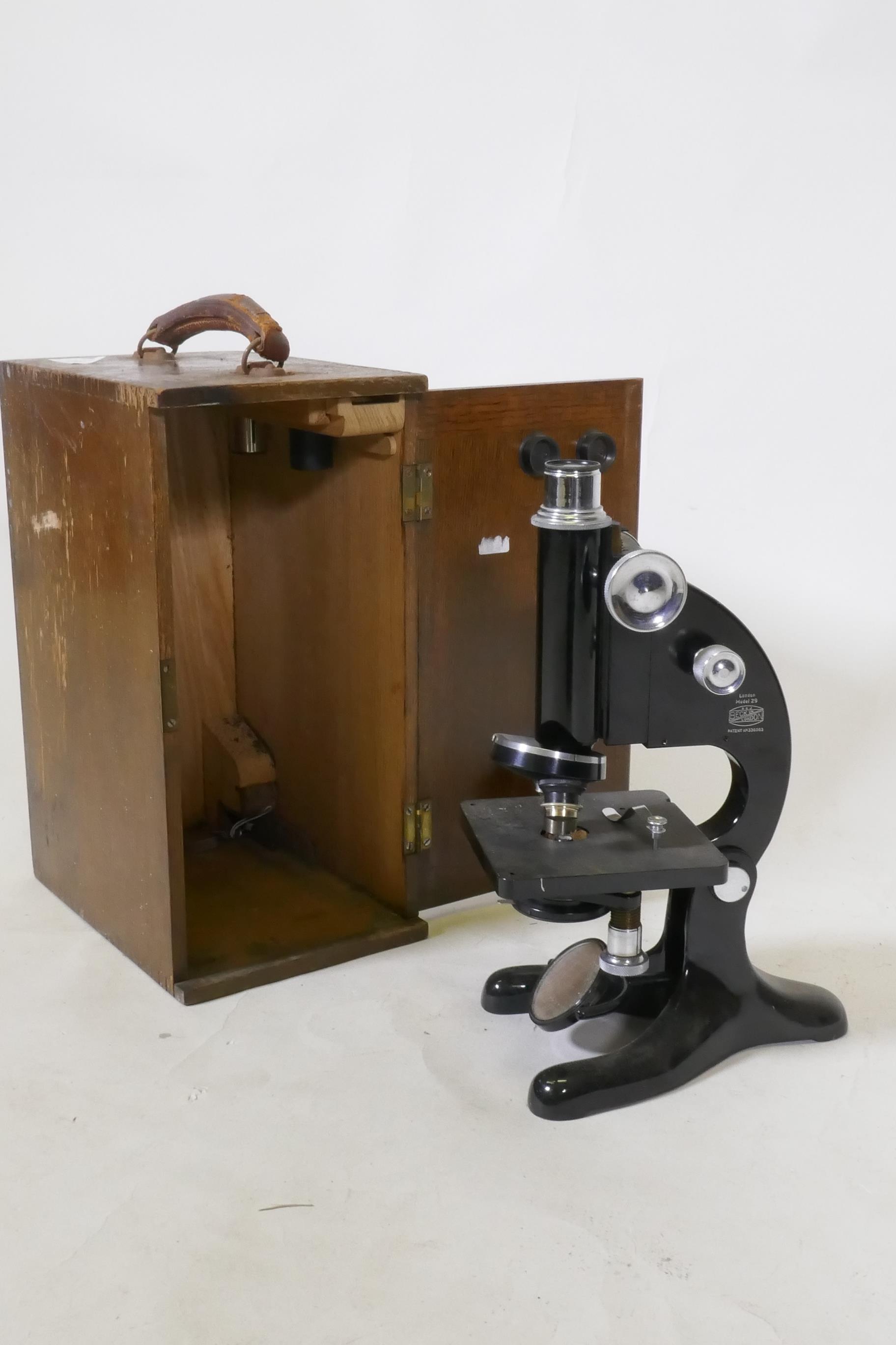 A Beck Ltd of London monocular microscope in wood case, 33cm high
