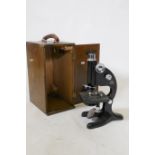 A Beck Ltd of London monocular microscope in wood case, 33cm high