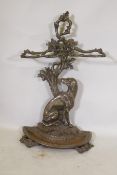 A Victorian style cast iron stick stand in the form of a seated dog with the legend Cave Canem, 75cm