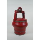 An antique Chinese red lacquered wood and metal bound wedding basket, 36cm high