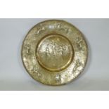 A Nuremburg brass alms dish, the central field with a depiction of Adam and Eve with the Tree of