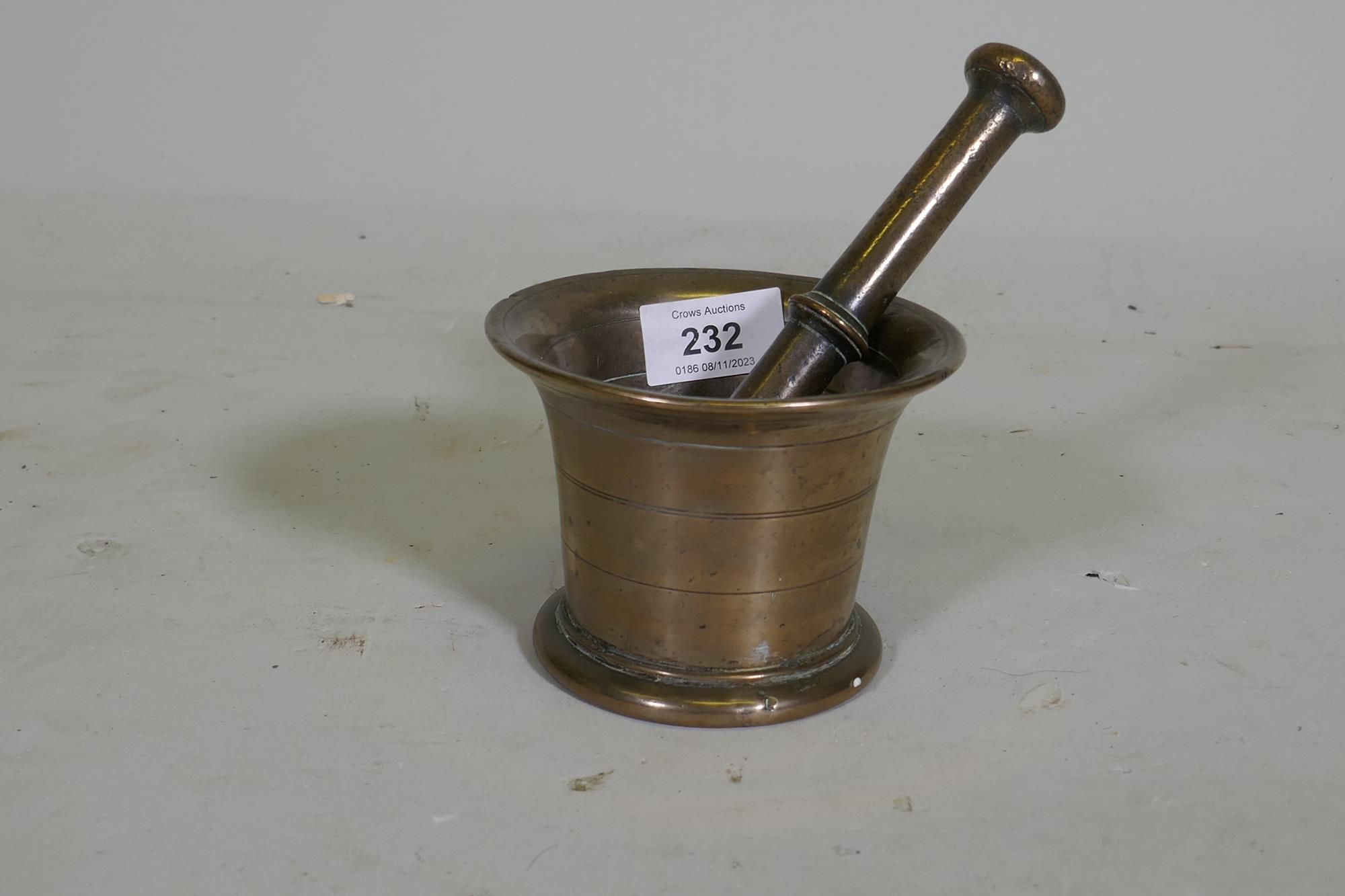 An C18th bronze mortar and pestle, 9cm high