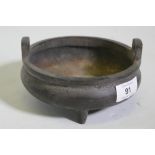 A Chinese bronze censer with two handles and seal mark to base, 15cm diameter