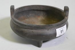 A Chinese bronze censer with two handles and seal mark to base, 15cm diameter