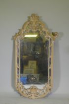 A carved and painted wall mirror, AF losses, 136cm high