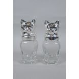 A pair of silver plated and glass salt and pepper shakers in the form of cats, 12cm high