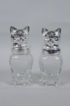 A pair of silver plated and glass salt and pepper shakers in the form of cats, 12cm high