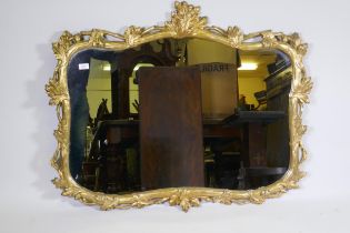 A carved and gilded pine wall mirror with oak and acorn decoration, early C20th, 114 x 92cm