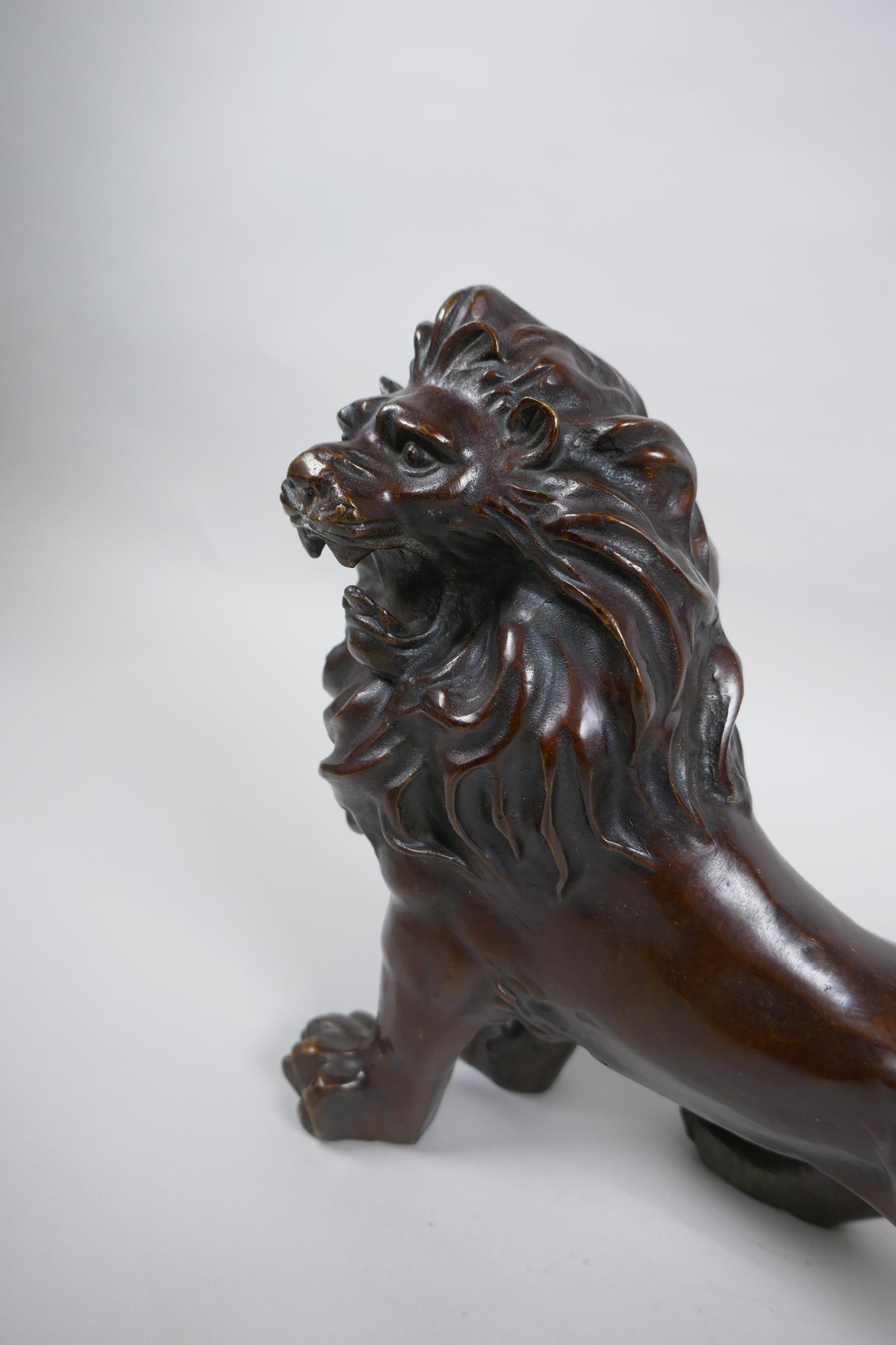 A filled bronze figure of a lion, 26cm long - Image 2 of 3