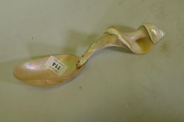 Antique mother of pearl spoon carved from a conch shell, 25cm long