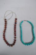 A string of graduated turquoise beads, together with a string of amber agate beads